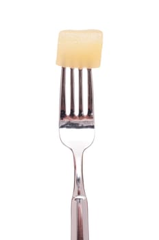 White isolated pickled mustard cucumber on a fork