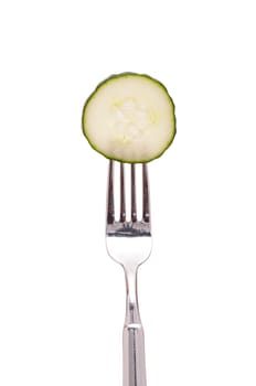 White cut-out slice of cucumber on a fork