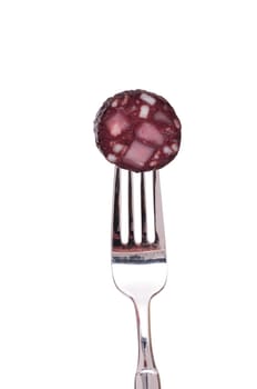 White cut-out slice of black sausage on a fork