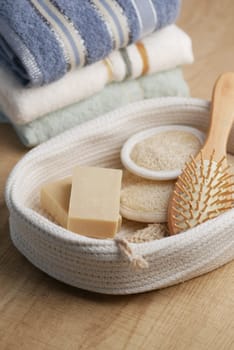Soft towels and natural products neatly organized in a woven basket.