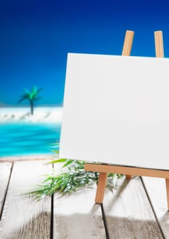 Blank white signboard on a wooden stand overlooking the ocean at a tropical resort for your greeting , menu, presentation or advertisement