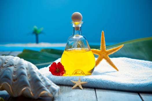 Aromatherapy wellness spa treatment with essential oil laid out on a deck in a tropical marine environment overlooking the sea