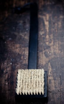 Black bath brush on wooden rustic background