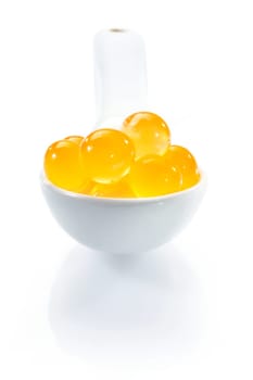 Molecular Caviar Bubbles on a white spoon.