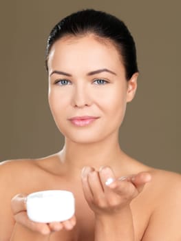 Portrait of beautiful woman, she holding cream container