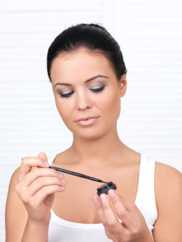 Portrait of beautiful woman, she doing makeup