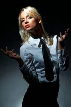 Blond model, business woman pose on black background