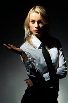 Blond model, business woman pose on black background
