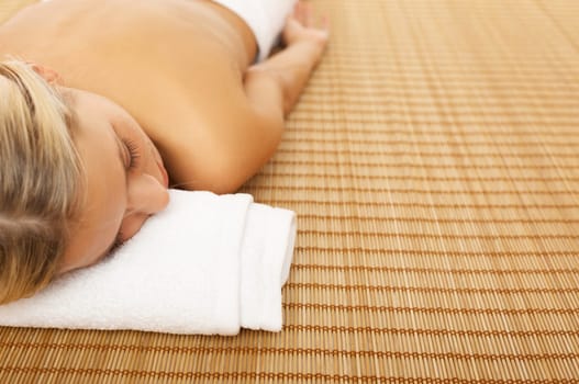 Portrait of Beautiful woman laying on bamboo mat