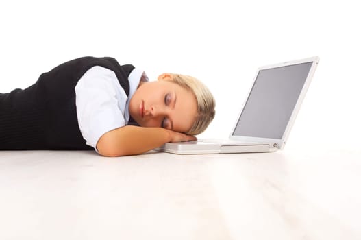 Businesswoman working on her laptop while lying down on the floor