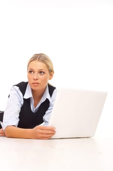 Businesswoman working on her laptop while lying down on the floor