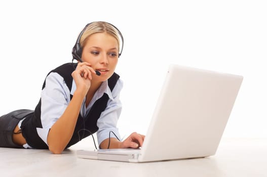 Businesswoman working on her laptop while lying down on the floor