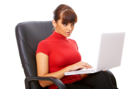 Businesswoman working on her laptop while sitting on chair