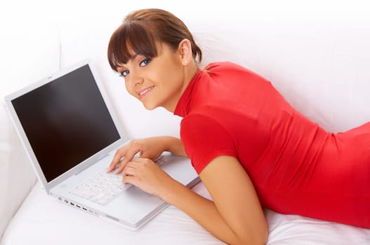 Young pretty women on white couch relaxing and using laptop computer