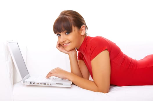 Young pretty women on white couch relaxing and using laptop computer