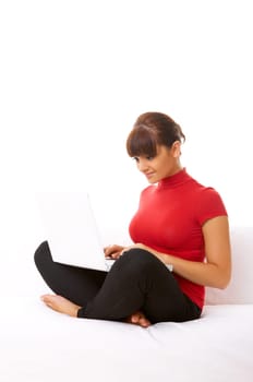 Young pretty women on white couch relaxing and using laptop computer