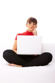 Young pretty women on white couch relaxing and using laptop computer