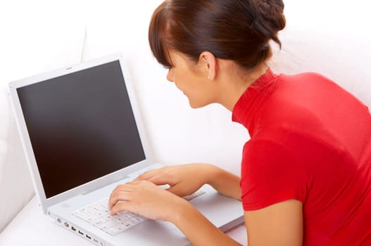 Young pretty women on white couch relaxing and using laptop computer