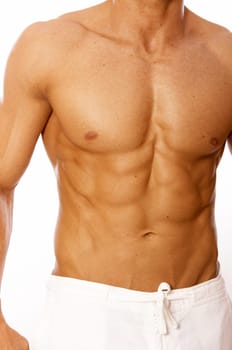 Muscular and tanned male torso isolated on white