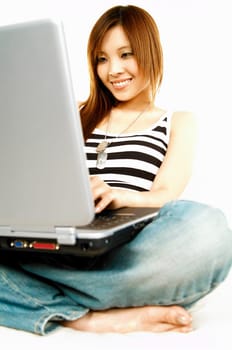 A young beautiful asian women working with her laptop computer