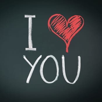 I Love You. Handwritten message on a chalkboard with an illustrated heart used as a symbol of love in this Valentines message.