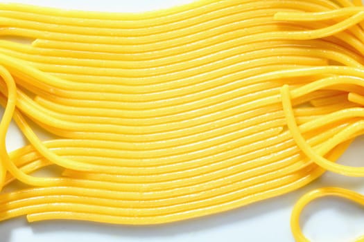 Cooked spaghetti in a row on white background
