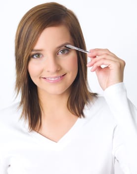 Portrait of beautiful young woman is doing her makeup
