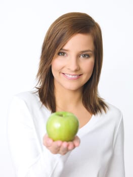 Portrait of beautiful young woman holding green apple
