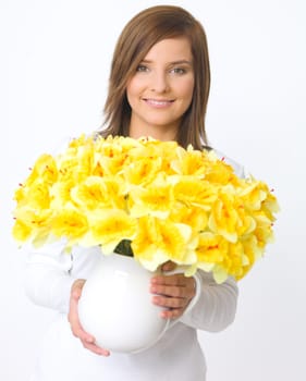 Portrait of beautiful young woman holding vase of flowers
