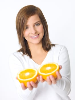 Portrait of beautiful young woman holding fresh orange fruit