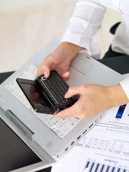 Portrait of beautiful and young business woman working on laptop