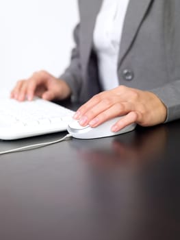 Portrait of beautiful and young business woman working on computer
