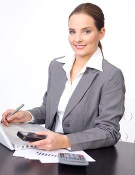 Portrait of beautiful and young business woman working on laptop