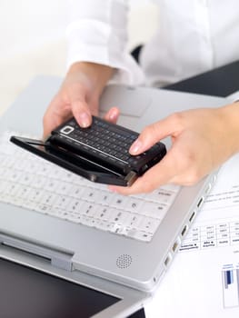 Portrait of beautiful and young business woman working on laptop