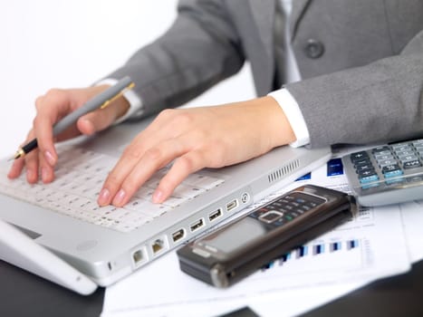 Portrait of beautiful and young business woman working on laptop