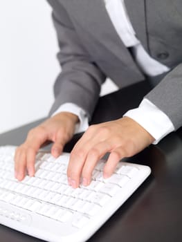 Portrait of beautiful and young business woman working on computer