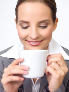 Portrait of beautiful and young business woman with coffee cup