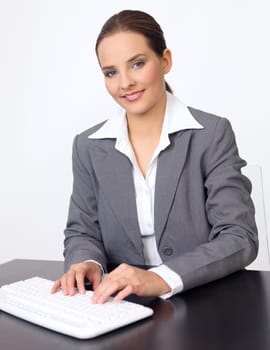 Portrait of beautiful and young business woman working on computer