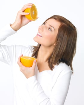Portrait of beautiful young woman holding fresh orange fruit