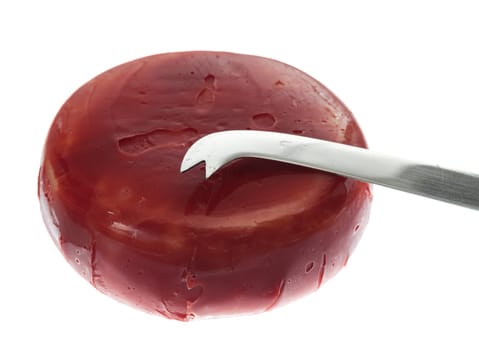 Circular round dutch covered in red wax protection with knife