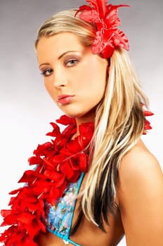 Sexy blonde girl with red hawaii flowers
