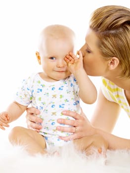 Young attractive mother kissing cute little baby