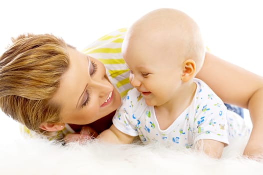 Young attractive mother kissing cute little baby
