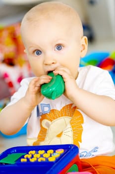 Portrait of sweet little baby boy with toys