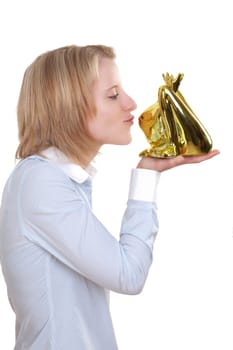 Young blonde woman holding a golden frog in her hand and wants to kiss them