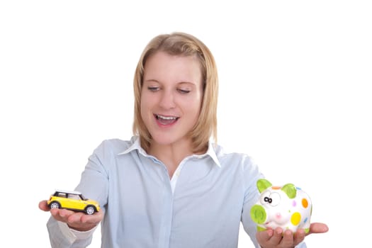 Young blonde woman holding a car in one hand and a piggy bank in the other