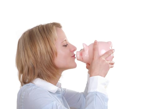 Young woman holding a pink piggy bank in her hand wants to kiss it