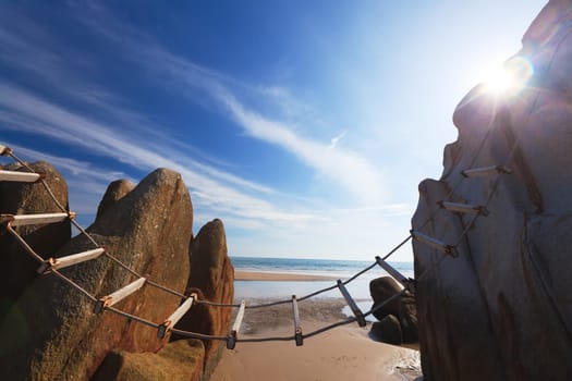 Rope-ladder between the rocks on the beach