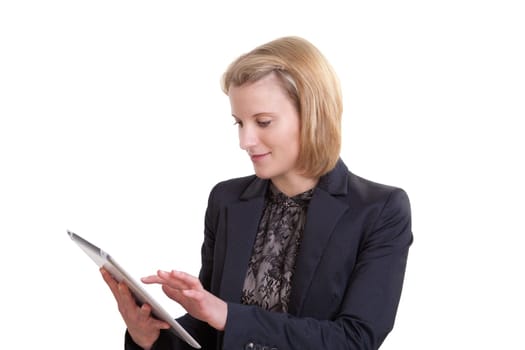 Young blonde businesswoman using a tablet pc standing in front of white background