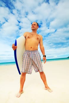 Man with body board on the tropical beach